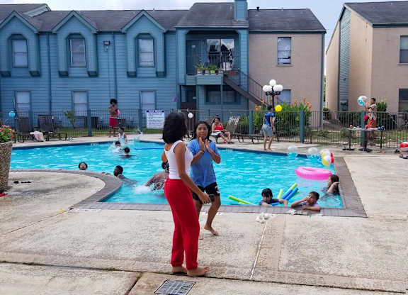 Two residents talking beside the pool at Waters at Westchase