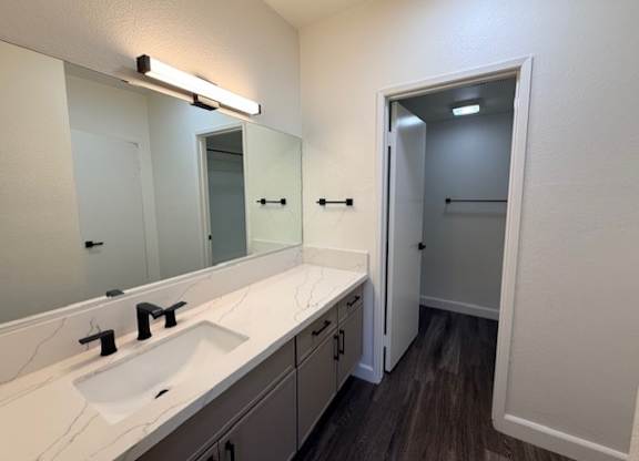 A bathroom with a sink and mirror.