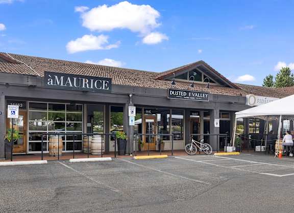 A Maurice storefront with a white tent in front.
