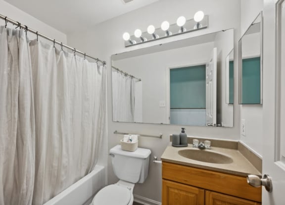 a bathroom with a shower and a sink and a toilet