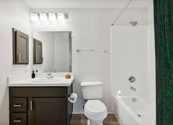 A white sink and toilet in a bathroom.