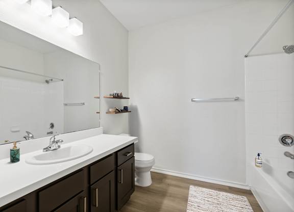 A white bathroom with a sink, toilet, and bathtub.
