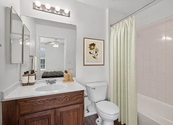 A white toilet sits next to a sink in a bathroom.