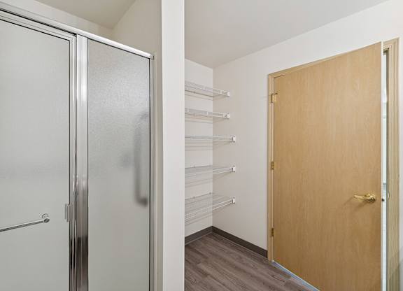 Bathroom with linen storage at Ballinger Court Senior Apartments in Edmonds WA
