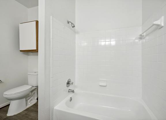 Bathroom with white tile at Fountains at Tidwell and The Enclave in Houston TX
