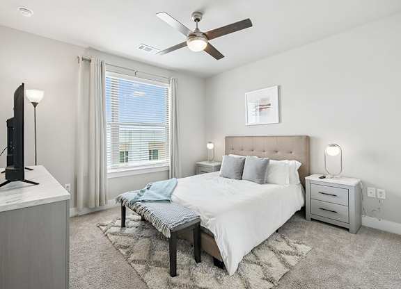 Bedroom with ceiling fan at The Sevens in Dallas TX