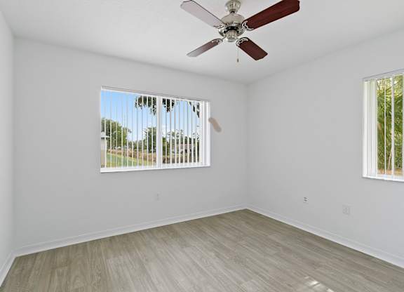 Bedroom with ceiling fan at Brenton at Abbey Park Apartments in West Palm Beach FL