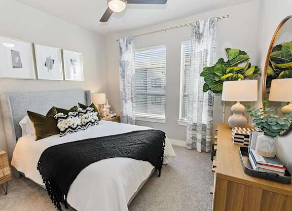 Bedroom with carpet and ceiling fan https://wave.webaim.org/report#/https://www.englandrunnorthapartments.com/