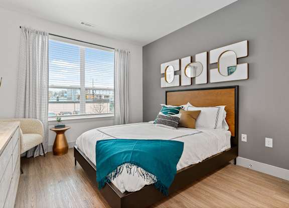 Bedroom with hardwood flooring at VERO Apartments in Chelsea MA