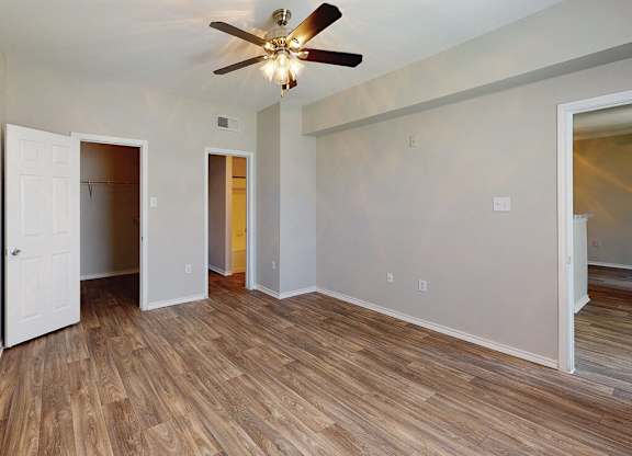 Bedroom with ceiling fan at Kensley Apartment Homes in Irving TX