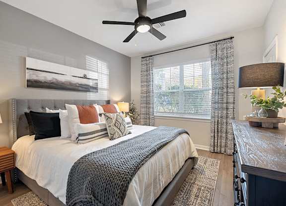 Bedroom with ceiling fan at River Pointe at Den Rock Park in Lawrence MA