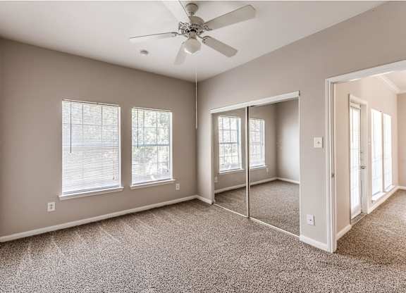 Bedroom with ceiling fan at Hollow Creek in Conroe TX