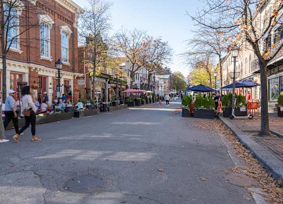 A street scene with people walking at Belhaven Apartments in Alexandria VA