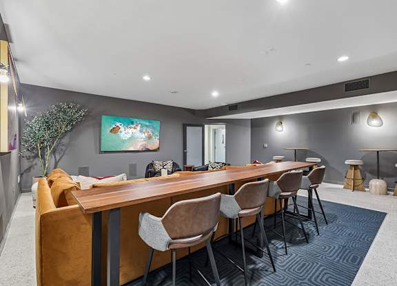 A conference room with a long table and chairs.