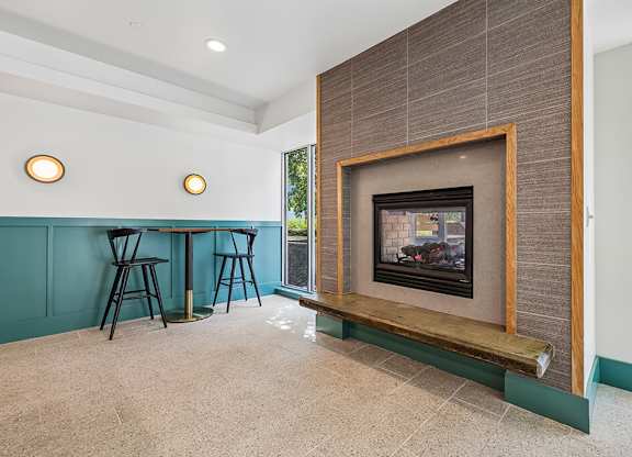 A modern living room with a fireplace and a dining table.