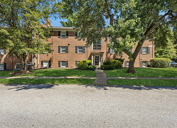 Building exterior with trees surrounding at Villages at Marley Station in Glen Burnie MD