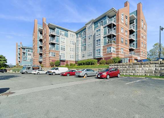 Building exterior and parking at Axis Admiral Hill Apartments in Chelsea MA