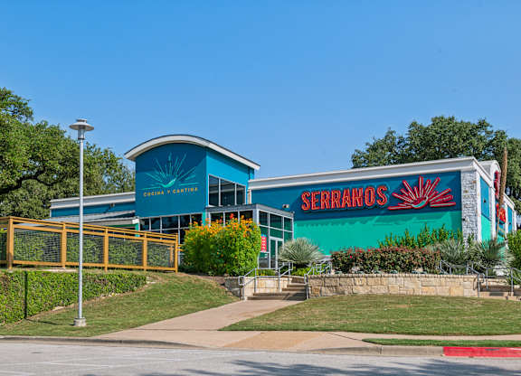 A blue building with a sign that says