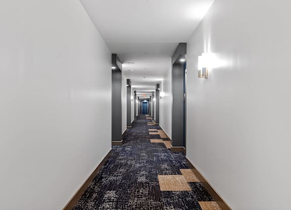 Carpeted hallway at VERO Apartments in Chelsea MA
