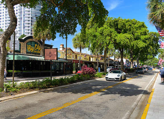 A street view with a car parked on the side of the road.