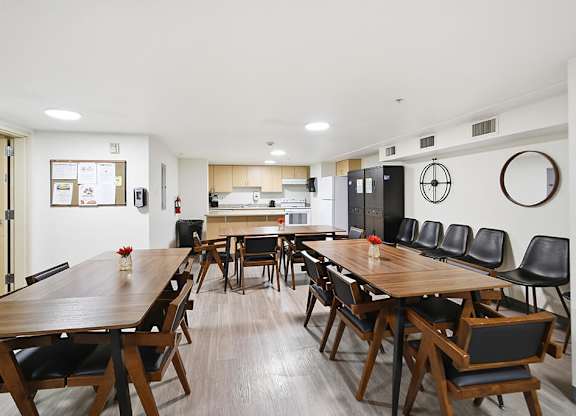 A conference room with a long table and chairs.