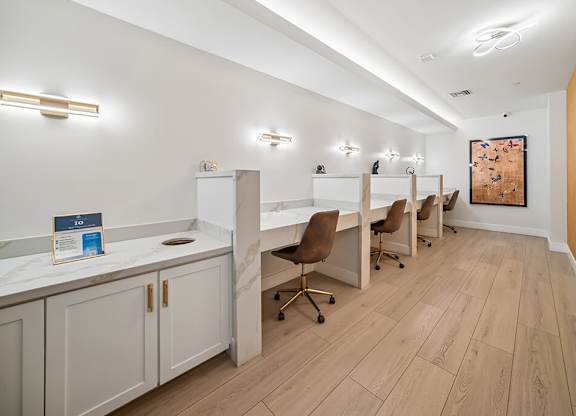 A row of brown chairs are lined up in a white room.