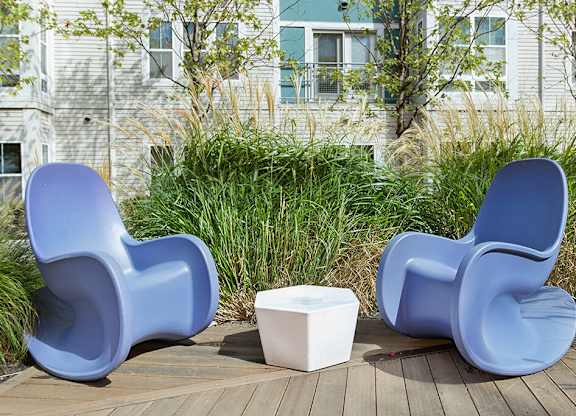 Courtyard lounge chairs at Axis Admiral Hill Apartments in Chelsea MA
