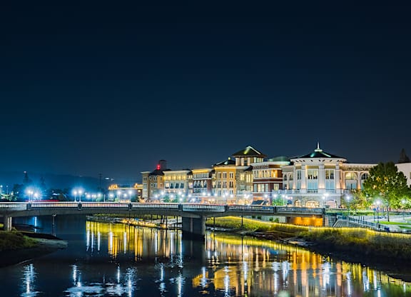 A cityscape at night with a river running through it