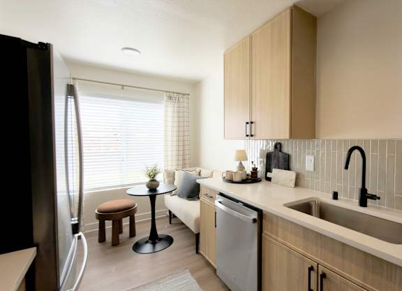 Model kitchen with sink at The Resort at Encinitas Apartments in Encinitas CA
