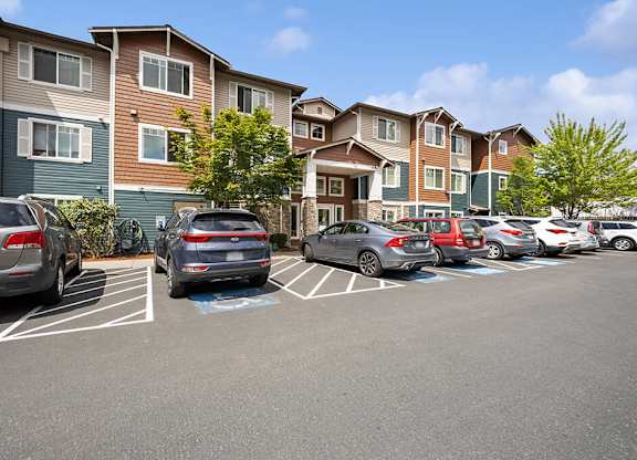 Exterior of apartments and parking area at Ballinger Court Senior Apartments in Edmonds WA