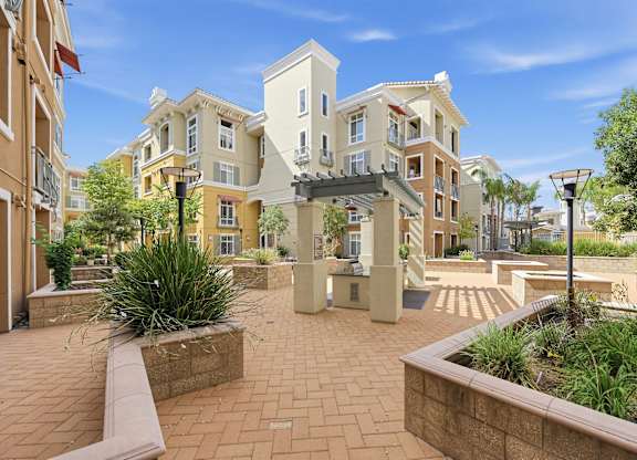 A sunny day at a courtyard surrounded by buildings.