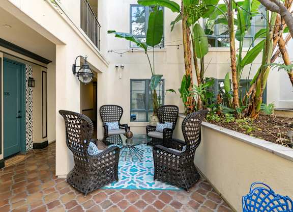 Exterior Courtyard Spanish Garden Seating Area at Cardio Equipment at Candara at Hancock Park Apartments in Los Angeles CA