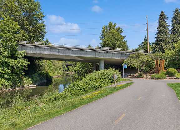 A bridge over a river with a road leading to it.