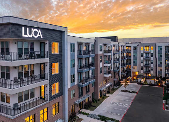 Outdoor sign at dusk at Luca Apartments in Austin TX