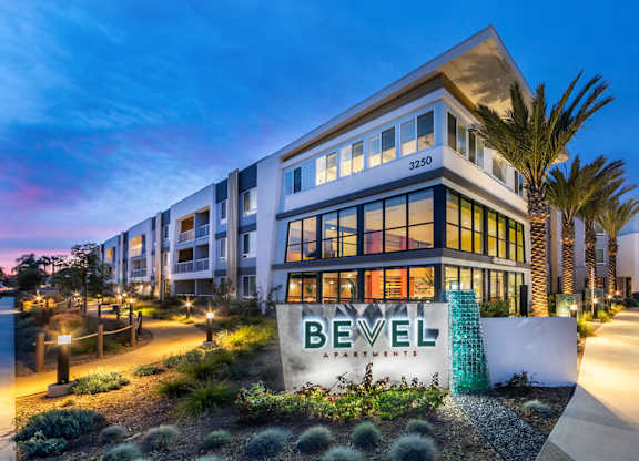 Monument sign at dusk at Bevel Apartments in San Diego CA