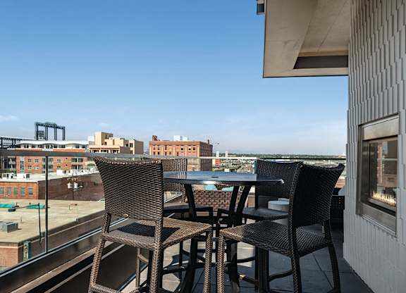 Rooftop deck with high tables at The Douglas Apartments in Denver