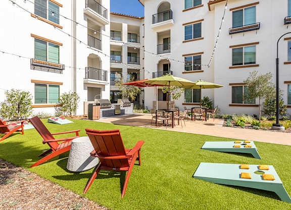 Exterior The Backyard Courtyard Game Lawn and Chairs at West Village Poway Apartments in Poway CA