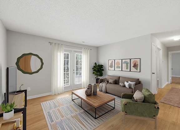Living room with large window at Greens of Pine Glen in Durham NC