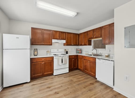 a kitchen with white appliances and wooden cabinets