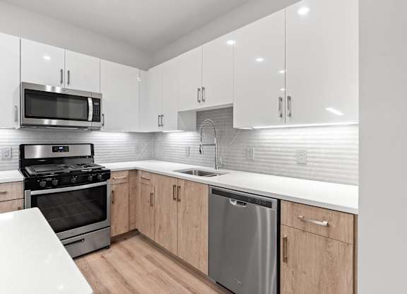 Kitchen pearl design with sleek appliances at VERO Apartments in Chelsea MA