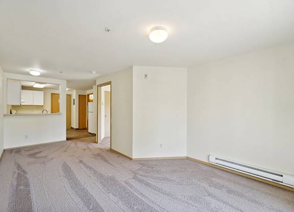 Living room with wood style flooring at Woodlands at Forbes Lake Apartments in Kirkland WA