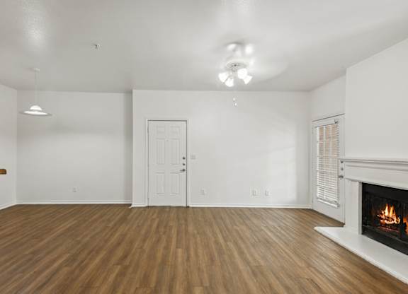 Living room with wood style flooring at Cypress View Villa Apartments in Weatherford TX