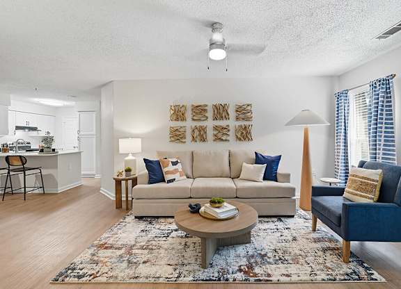 Living room and view of kitchen at Chroma Park Apartments in Austell GA