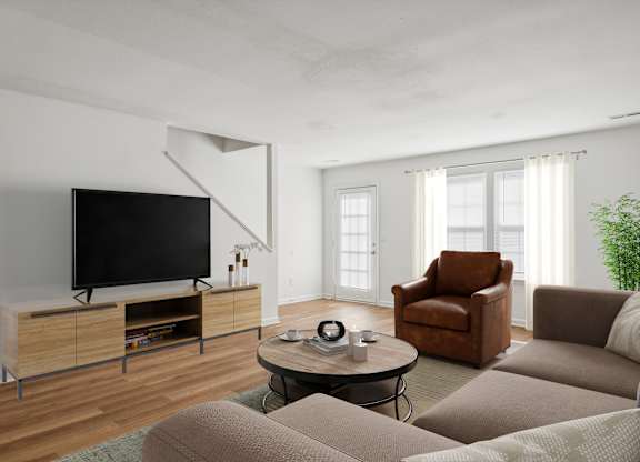 A living room with a brown leather chair and a black television.
