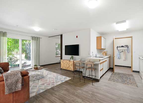 A living room with a brown chair and a white couch.