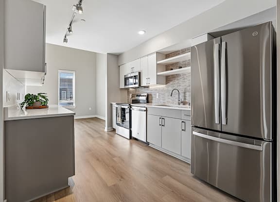 A modern kitchen with a refrigerator on the right.