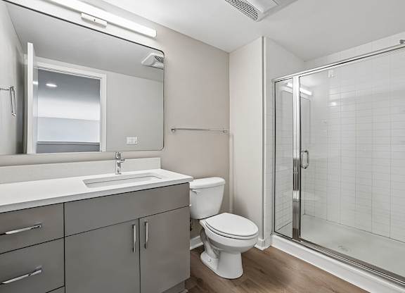 A white toilet sits next to a sink in a bathroom.
