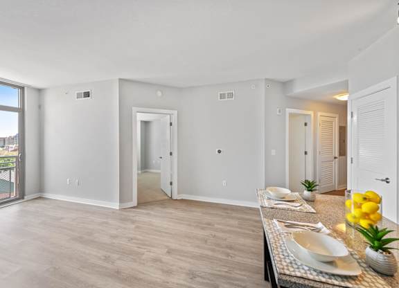 Model living area with wood style flooring at Bradley Braddock Road Station Apartments in Alexandria VA