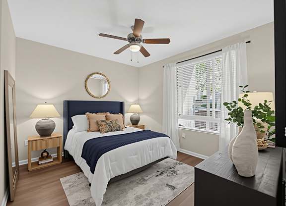 A bedroom with a bed, a ceiling fan, and a window with blinds.