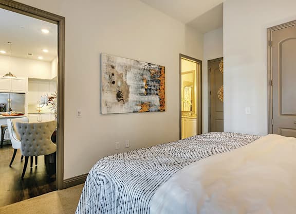 Model Bedroom with living room view at The Huntington Apartments in Plano TX